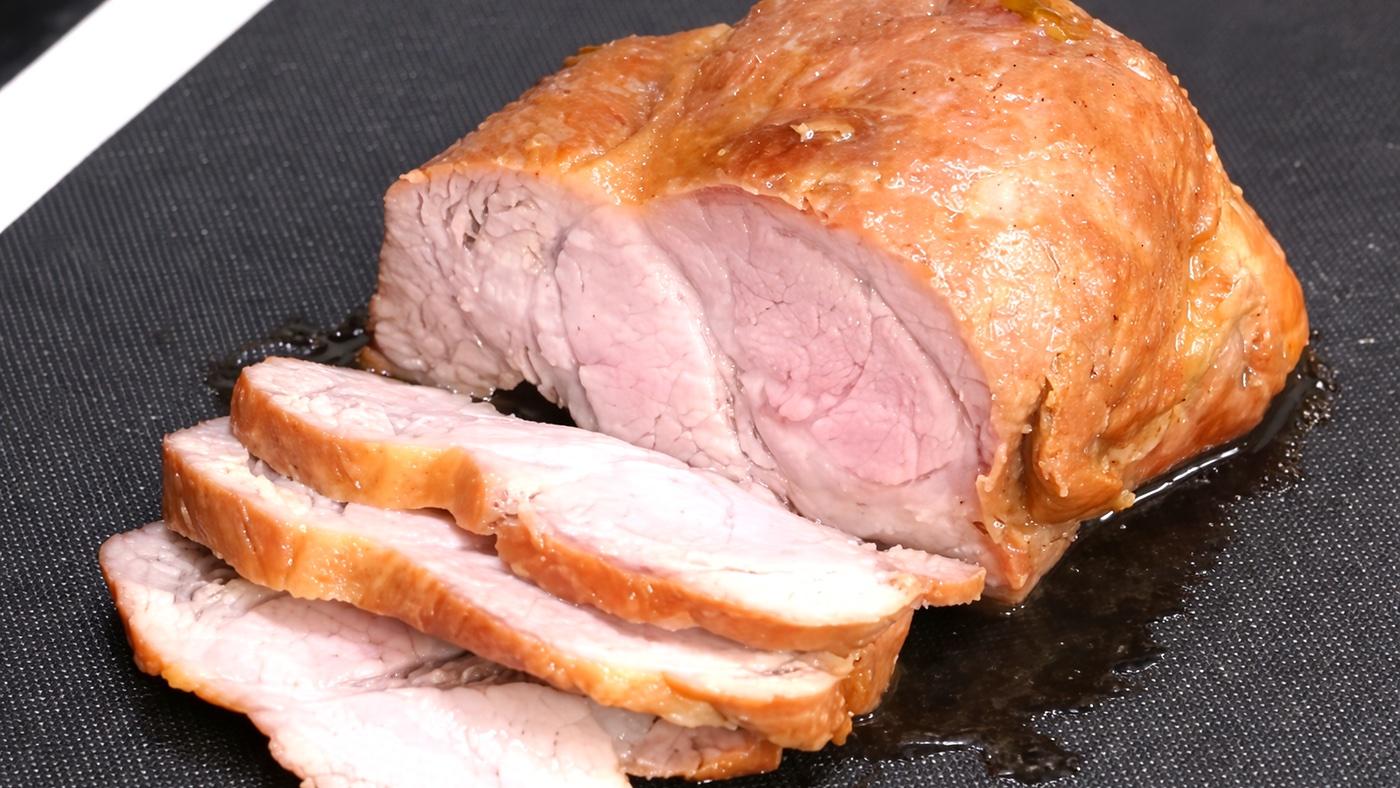 Sliced chashu pork resting on a cutting board.